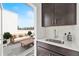 Convenient wet bar with stylish sink, with sliding glass door access to a deck and outdoor furniture at 321 15Th N St, St Petersburg, FL 33705