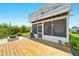 Elevated wood deck and patio leading to the screened in porch and fire pit at 3312 Holly Springs Dr, Hernando Beach, FL 34607