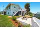 Expansive backyard featuring a fire pit, dock, and multiple outdoor entertainment areas at 3312 Holly Springs Dr, Hernando Beach, FL 34607