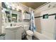 Charming bathroom featuring a shower/tub combo, white vanity, and unique wood plank ceiling at 3312 Holly Springs Dr, Hernando Beach, FL 34607