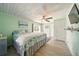 The airy bedroom features wooden floors, a ceiling fan, and access to multiple doors at 3312 Holly Springs Dr, Hernando Beach, FL 34607