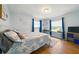 Charming bedroom with two windows and natural light, complemented by blue accents and wood flooring at 3312 Holly Springs Dr, Hernando Beach, FL 34607