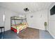 Clean bedroom features a bunk bed, wood-look ceiling, and simple mermaid-themed decor creating a fun space at 3312 Holly Springs Dr, Hernando Beach, FL 34607