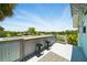 Outdoor deck with bar, seating, and a view of the surrounding neighborhood and landscape at 3312 Holly Springs Dr, Hernando Beach, FL 34607