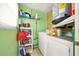 Functional laundry room with storage shelves, washer, and dryer units at 3312 Holly Springs Dr, Hernando Beach, FL 34607