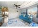 Inviting living room with coffered ceiling, bright blue sofa, nautical decor, and an open floor plan at 3312 Holly Springs Dr, Hernando Beach, FL 34607