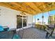 Enclosed patio with casual dining set and exterior door, perfect for relaxation and outdoor enjoyment at 3312 Holly Springs Dr, Hernando Beach, FL 34607