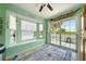 Bright sunroom with bay windows, natural light, and access to an outdoor patio at 3312 Holly Springs Dr, Hernando Beach, FL 34607