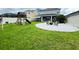 Spacious backyard featuring a fire pit area, playground, and lush green grass at 33560 Castaway Loop, Wesley Chapel, FL 33543