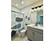 Neutral bathroom featuring a vanity, mirror, decorative shower curtain and framed art at 33560 Castaway Loop, Wesley Chapel, FL 33543