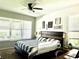 Comfortable bedroom with natural light, ceiling fan, wood furniture and decorative wall art at 33560 Castaway Loop, Wesley Chapel, FL 33543