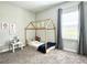 Bedroom features a unique wooden bed frame, carpet and a window with curtains at 33560 Castaway Loop, Wesley Chapel, FL 33543