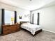 Neutral bedroom featuring carpet, gray curtains, and decorative wall art at 33560 Castaway Loop, Wesley Chapel, FL 33543