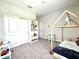 Bedroom featuring carpet, bed with wooden frame, white shelving and closet at 33560 Castaway Loop, Wesley Chapel, FL 33543