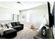 Bright bonus room featuring a dark gray sofa, tent, and lots of natural light at 33560 Castaway Loop, Wesley Chapel, FL 33543