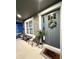 Charming front porch featuring a gray front door, window, wicker seating, and a 'Home Sweet Home' mat at 33560 Castaway Loop, Wesley Chapel, FL 33543