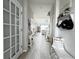 Long hallway leading to the living areas with lots of natural light and decor at 33560 Castaway Loop, Wesley Chapel, FL 33543