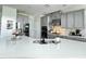 Modern kitchen with gray cabinets, stainless steel appliances, and a spacious white countertop island at 33560 Castaway Loop, Wesley Chapel, FL 33543
