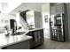 Kitchen island with stainless steel refrigerator and gray cabinets offers ample counter space and storage at 33560 Castaway Loop, Wesley Chapel, FL 33543