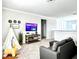 Bright living room with a tent, entertainment center, and gray carpet at 33560 Castaway Loop, Wesley Chapel, FL 33543