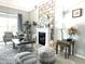 Bright living room with fireplace, neutral decor, and a large window letting in natural light at 33560 Castaway Loop, Wesley Chapel, FL 33543