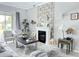 Bright living room featuring a fireplace, neutral decor, large window, and stylish furnishings at 33560 Castaway Loop, Wesley Chapel, FL 33543