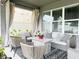 Relaxing covered patio with comfortable seating, an area rug, and string lights at 33560 Castaway Loop, Wesley Chapel, FL 33543