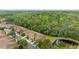 Aerial view of townhomes in a community surrounded by lush greenery and ponds at 4149 Winding River Way, Land O Lakes, FL 34639