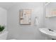 Clean and minimalist bathroom with white fixtures, a mirror, and modern decor at 4149 Winding River Way, Land O Lakes, FL 34639