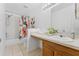 Bathroom featuring a shower-tub combo, vanity sink, and updated lighting at 4149 Winding River Way, Land O Lakes, FL 34639