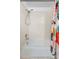 Bathroom with a white tub-shower combo featuring a shower head and colorful shower curtain at 4149 Winding River Way, Land O Lakes, FL 34639