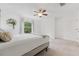 Bedroom with neutral carpet, ceiling fan, closet, and a window that brings in plenty of natural light at 4149 Winding River Way, Land O Lakes, FL 34639