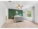 Carpeted bedroom with accent wall, ceiling fan, and a window that brings in plenty of natural light at 4149 Winding River Way, Land O Lakes, FL 34639