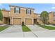 Inviting two-story townhome featuring a private garage and well-maintained landscaping at 4149 Winding River Way, Land O Lakes, FL 34639