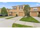 Townhome exterior features a two-car garage and neatly maintained landscaping at 4149 Winding River Way, Land O Lakes, FL 34639