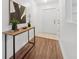 Bright hallway with hardwood floors, decorative table and doorway ahead at 4149 Winding River Way, Land O Lakes, FL 34639