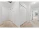 Hallway with carpet flooring and several closets offering great storage solutions at 4149 Winding River Way, Land O Lakes, FL 34639