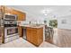 Open kitchen with stainless steel appliances and a view of the dining area at 4149 Winding River Way, Land O Lakes, FL 34639