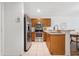 Open kitchen with stainless steel appliances and eat-in countertop at 4149 Winding River Way, Land O Lakes, FL 34639