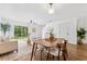 Bright living and dining area features wood floors, recessed lighting, and sliding glass door to backyard at 4149 Winding River Way, Land O Lakes, FL 34639
