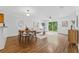 Bright living room with hardwood floors, ceiling fan, and dining space at 4149 Winding River Way, Land O Lakes, FL 34639