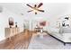 Open-concept living room with wood floors, a modern ceiling fan, and easy access to the kitchen and dining area at 4149 Winding River Way, Land O Lakes, FL 34639