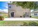 Home's backyard with a concrete patio that provides views of the well-maintained lawn at 4227 Bethpage Ct, Wesley Chapel, FL 33543