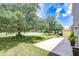 Spacious backyard with patio, shade trees, and a serene water view at 4227 Bethpage Ct, Wesley Chapel, FL 33543