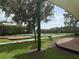 Outdoor basketball court with covered benches, mature trees, landscaping, and shade structure at 4227 Bethpage Ct, Wesley Chapel, FL 33543