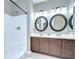 Bathroom featuring double sinks with dark wood cabinets and walk-in shower at 4227 Bethpage Ct, Wesley Chapel, FL 33543