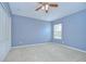 Bedroom with a ceiling fan and a window that provides natural light, creating a peaceful ambiance at 4227 Bethpage Ct, Wesley Chapel, FL 33543