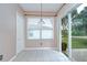 Bright breakfast nook with sliding glass door to outdoor living space at 4227 Bethpage Ct, Wesley Chapel, FL 33543
