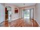 Dining room featuring hardwood floors, chandelier, and views into the kitchen at 4227 Bethpage Ct, Wesley Chapel, FL 33543
