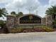 Stone community sign with colorful flowers at Country Walk community entrance with landscaping at 4227 Bethpage Ct, Wesley Chapel, FL 33543